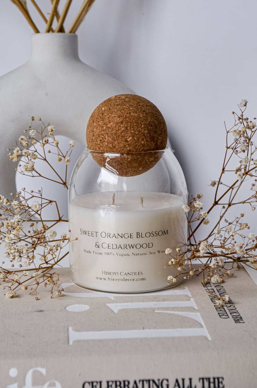 Designer scented candle in a glass jar with a ball‑shaped lid