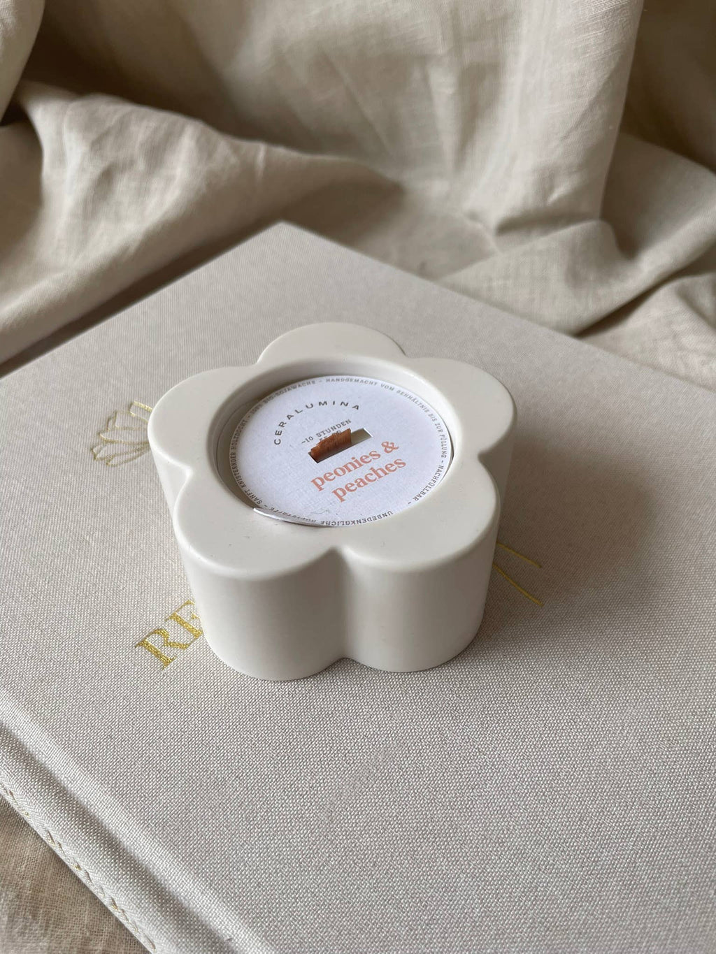 ‘Peonies & Peaches’ soy‑wax scented candle.